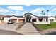 Beautiful home with a three-car garage, concrete walkway, and lush front yard at 6114 E Calle Del Norte --, Scottsdale, AZ 85251