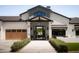 Stunning home featuring a covered front entry, manicured bushes and a striking front door at 6114 E Calle Del Norte --, Scottsdale, AZ 85251