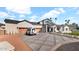 Elegant home featuring a geometric driveway, three-car garage, and manicured landscaping at 6114 E Calle Del Norte --, Scottsdale, AZ 85251