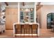 Kitchen island with counter seating and custom cabinets and shelving at 6114 E Calle Del Norte --, Scottsdale, AZ 85251