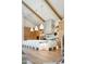 Bright kitchen with large island, white counter seating, wooden beams, and modern hanging lights at 6114 E Calle Del Norte --, Scottsdale, AZ 85251