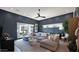 Living room featuring dark accent wall, recessed lighting, and sliding glass doors at 6114 E Calle Del Norte --, Scottsdale, AZ 85251