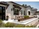 Outdoor dining area with a modern fire pit, ample seating, and stylish decor at 6114 E Calle Del Norte --, Scottsdale, AZ 85251