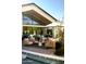 Inviting outdoor living area with stylish seating and large windows overlooking the pool at 6114 E Calle Del Norte --, Scottsdale, AZ 85251