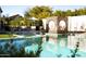 Backyard pool with modern cube-shaped seating, lounge chairs, and lush landscaping at 6114 E Calle Del Norte --, Scottsdale, AZ 85251