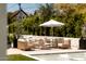 Relaxing poolside lounge area with stylish patio furniture and shade umbrella, perfect for enjoying sunny days at 6114 E Calle Del Norte --, Scottsdale, AZ 85251