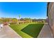 Expansive backyard with synthetic grass, desert landscaping, view of a mountain, and travertine pavers at 6212 E Lonesome Trl, Cave Creek, AZ 85331