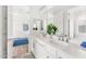 Bright bathroom featuring double sinks, white cabinetry, modern fixtures and a view into an adjacent bedroom at 6212 E Lonesome Trl, Cave Creek, AZ 85331