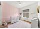 Charming bedroom with pink accent wall, decorative touches, window, ceiling fan and hardwood floors at 6212 E Lonesome Trl, Cave Creek, AZ 85331