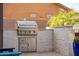 Built-in outdoor kitchen featuring a stainless steel grill and stone accents for sophisticated outdoor entertaining at 6212 E Lonesome Trl, Cave Creek, AZ 85331