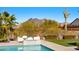 Beautiful pool area with mountain views, modern seating, and lush landscaping for a relaxing outdoor oasis at 6212 E Lonesome Trl, Cave Creek, AZ 85331