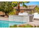 Stunning pool area with a waterfall feature, lounge chairs, and lush landscaping for ultimate relaxation at 6212 E Lonesome Trl, Cave Creek, AZ 85331