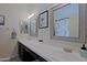 Bathroom featuring double sinks, framed mirrors, modern fixtures, and neutral decor for a clean, updated look at 6228 W Caribbean Ln, Glendale, AZ 85306