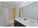 Bathroom features a double sink vanity, a large mirror, and a tiled shower/tub combo for a functional space at 6228 W Caribbean Ln, Glendale, AZ 85306