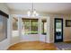 Bright dining area features a large bay window with backyard views and blue door at 6228 W Caribbean Ln, Glendale, AZ 85306