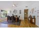 Bright dining room area featuring hard wood floors, chandelier, and a view of the entryway at 6228 W Caribbean Ln, Glendale, AZ 85306