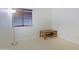 Bright empty room with light tile flooring, a lamp, natural light, and minimal decor, ready for customization at 6228 W Caribbean Ln, Glendale, AZ 85306