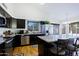 Modern kitchen with granite countertops, stainless steel appliances, and a breakfast bar for casual dining at 6228 W Caribbean Ln, Glendale, AZ 85306