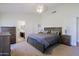 Serene main bedroom with neutral tones, plush carpeting, and an en-suite bathroom with a walk-in closet at 6228 W Caribbean Ln, Glendale, AZ 85306