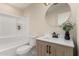 Bathroom featuring modern vanity, round mirror, and shower-tub combo at 6812 S 41St Pl, Phoenix, AZ 85042