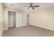 Bedroom featuring a closet with sliding doors, neutral carpet and a ceiling fan at 6812 S 41St Pl, Phoenix, AZ 85042