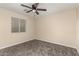 Bedroom featuring neutral walls, carpet flooring, a ceiling fan, and window with blinds at 6812 S 41St Pl, Phoenix, AZ 85042