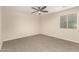 Bedroom with neutral carpet, ceiling fan, and natural light from a window at 6812 S 41St Pl, Phoenix, AZ 85042