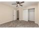 Bedroom featuring neutral walls, carpet flooring, ceiling fan, and closet with sliding doors at 6812 S 41St Pl, Phoenix, AZ 85042