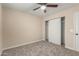 Bedroom featuring neutral walls, carpet flooring, ceiling fan, and closet with sliding doors at 6812 S 41St Pl, Phoenix, AZ 85042