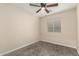 Bedroom featuring neutral walls, carpet flooring, ceiling fan, and window with blinds at 6812 S 41St Pl, Phoenix, AZ 85042