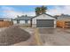 Inviting single-story home with a gray garage door, stone accents, and desert landscaping potential at 6812 S 41St Pl, Phoenix, AZ 85042