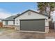 Single-story home showcasing a gray two-car garage, modern lighting, and stylish stone detailing at 6812 S 41St Pl, Phoenix, AZ 85042