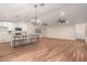 Open-concept kitchen featuring island seating, white cabinets, and stainless steel appliances at 6812 S 41St Pl, Phoenix, AZ 85042