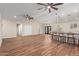 Spacious living room boasts wood-look tile, vaulted ceiling, fan, and a kitchen with island seating at 6812 S 41St Pl, Phoenix, AZ 85042