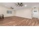 Open-concept living space with wood-look tile, lots of natural light, and access to the kitchen area at 6812 S 41St Pl, Phoenix, AZ 85042