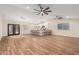 Spacious living room featuring wood-look tile flooring, a center island, and modern pendant lighting at 6812 S 41St Pl, Phoenix, AZ 85042