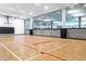 Community basketball court with wood floors, hoops, and windows at 7121 E Rancho Vista Dr # 3001, Scottsdale, AZ 85251