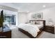 Modern bedroom with neutral colors, platform bed, gray carpet, and natural light at 7121 E Rancho Vista Dr # 3001, Scottsdale, AZ 85251