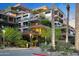 Exterior view of the property featuring palm trees and lush balconies, showcasing its urban oasis feel and architecture at 7121 E Rancho Vista Dr # 3001, Scottsdale, AZ 85251