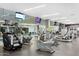 Well-equipped fitness center with cardio machines, TVs, and views of the pool through expansive glass walls at 7121 E Rancho Vista Dr # 3001, Scottsdale, AZ 85251