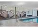 Bright indoor pool with basketball court backdrop and blue tile at 7121 E Rancho Vista Dr # 3001, Scottsdale, AZ 85251