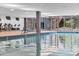 Indoor community pool with lounge chairs, gym, and outside access at 7121 E Rancho Vista Dr # 3001, Scottsdale, AZ 85251