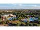 An aerial view of a community pool with water slides, a splash pad, and a recreation center at 8486 W Mantle Way, Florence, AZ 85132