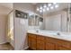 Bathroom featuring double sink vanity, large mirror, vanity lights, shower-tub combo with curtain at 9211 W Charleston Ave, Peoria, AZ 85382