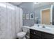 Bathroom with white vanity, dark fixtures, framed botanical prints, and shower-tub combination at 9211 W Charleston Ave, Peoria, AZ 85382