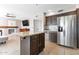 Spacious kitchen featuring an island, stainless steel refrigerator, and tile flooring at 9211 W Charleston Ave, Peoria, AZ 85382