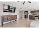 Inviting living room flows into the kitchen area and features a flatscreen tv on the wall at 9211 W Charleston Ave, Peoria, AZ 85382