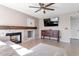 Cozy living room features a fireplace with tile surround and a ceiling fan for added comfort at 9211 W Charleston Ave, Peoria, AZ 85382