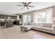 Open-concept kitchen and living room with tile floors, a ceiling fan, and lots of natural light at 9211 W Charleston Ave, Peoria, AZ 85382