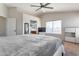 Bright main bedroom with a ceiling fan, carpet, and a view into the en suite bathroom at 9211 W Charleston Ave, Peoria, AZ 85382